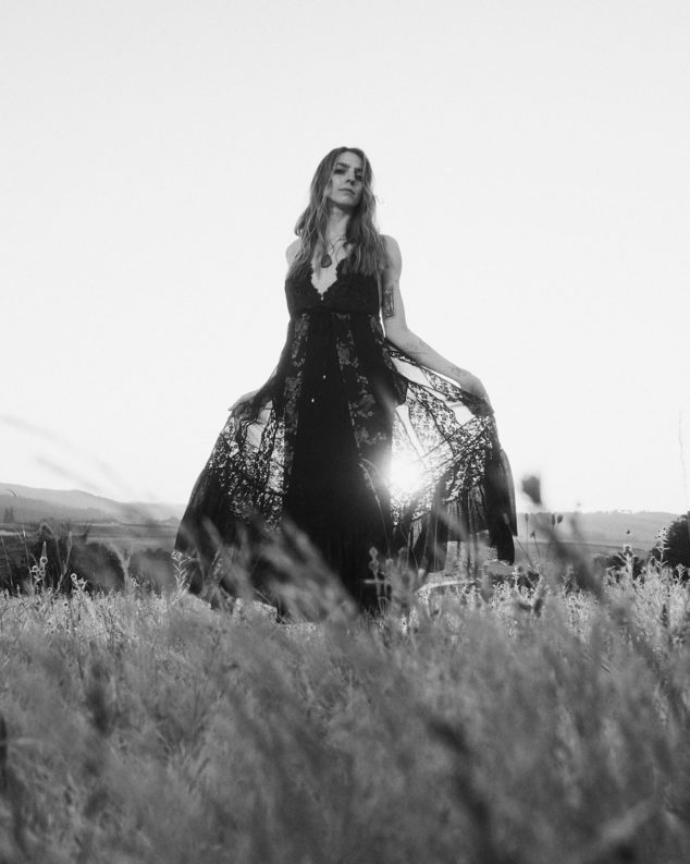 black and white photography of a woman twirling in sunset