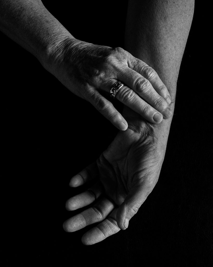 black and white image of woman checking a pulse with her fingers
